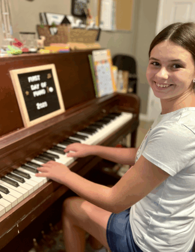 girl smiling at piano